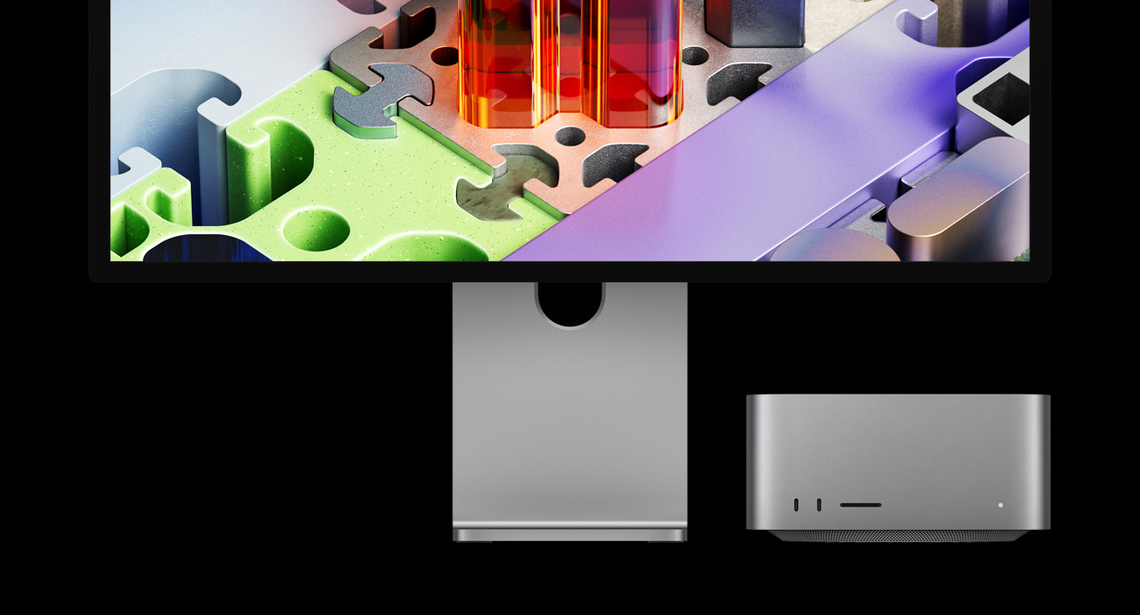 Mac Studio conectado ao Studio Display XDR, aparelho posicionado embaixo da tela. O Studio Display XDR tem um papel de parede tridimensional semelhante a um quebra-cabeça