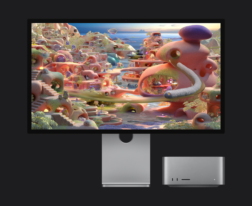 Em uma imagem de desenho animado no Studio Display XDR com o Mac Studio embaixo, uma criatura semelhante a um verme aparece saindo de um túnel e se move pela tela